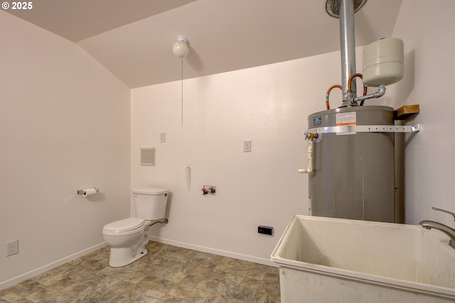 bathroom with sink, vaulted ceiling, strapped water heater, and toilet