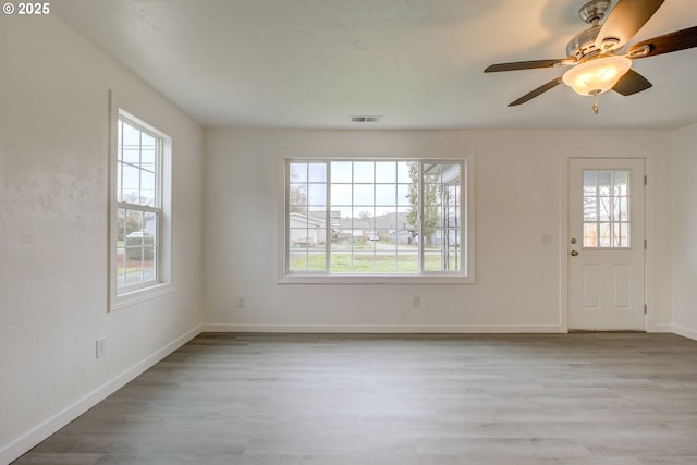 foyer entrance featuring ceiling fan, light wood-type flooring, and plenty of natural light