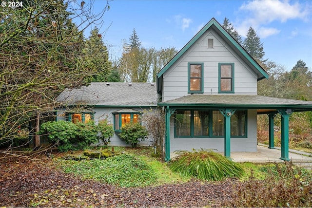 rear view of property with a sunroom