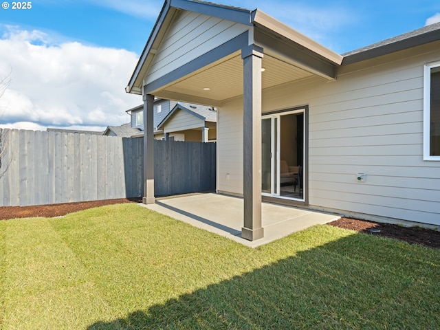 view of yard featuring fence and a patio