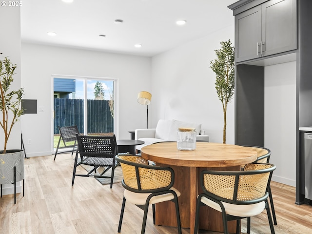 dining room with light wood-style floors, baseboards, and recessed lighting