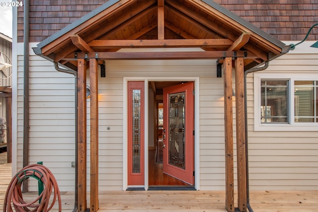 view of exterior entry with a deck