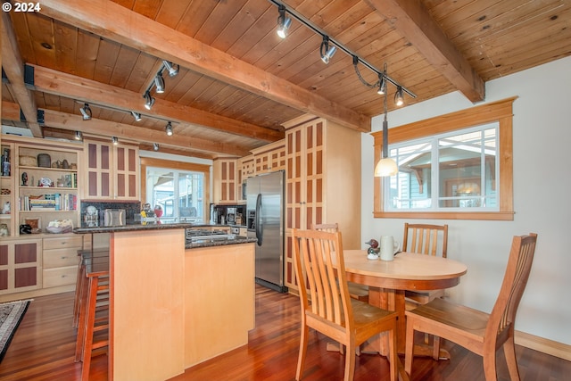 kitchen with plenty of natural light, wood ceiling, stainless steel refrigerator with ice dispenser, and track lighting