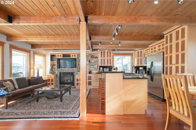 kitchen with dark wood-type flooring, wood ceiling, beamed ceiling, and stainless steel fridge with ice dispenser