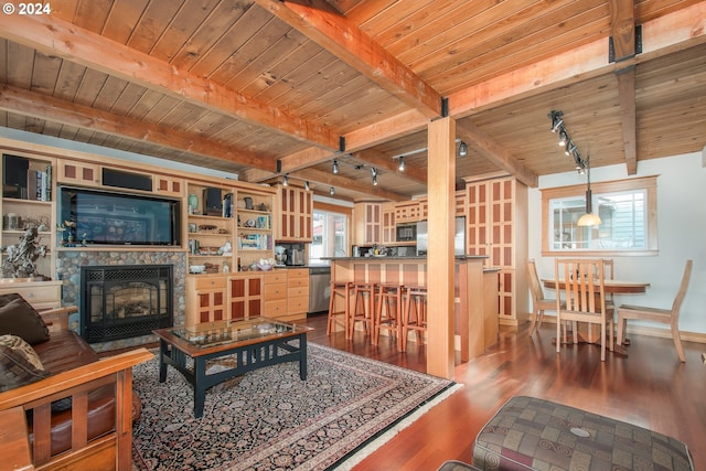 living room featuring track lighting, dark wood-type flooring, wood ceiling, and beamed ceiling