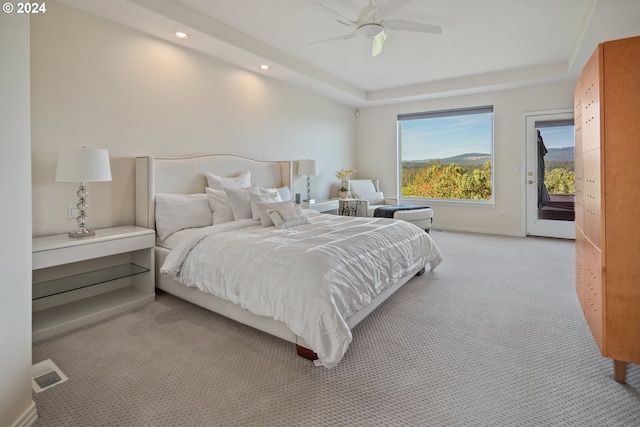 bedroom featuring access to outside, light colored carpet, and ceiling fan