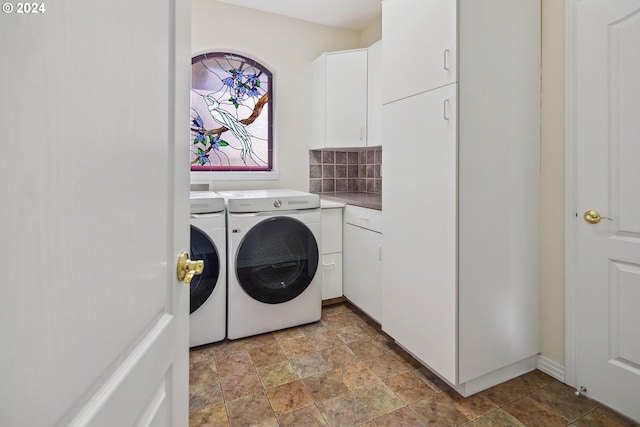 clothes washing area with cabinets and independent washer and dryer