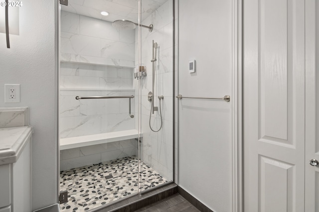 bathroom featuring a shower with door