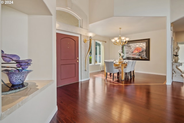 foyer entrance featuring dark wood-type flooring and a notable chandelier