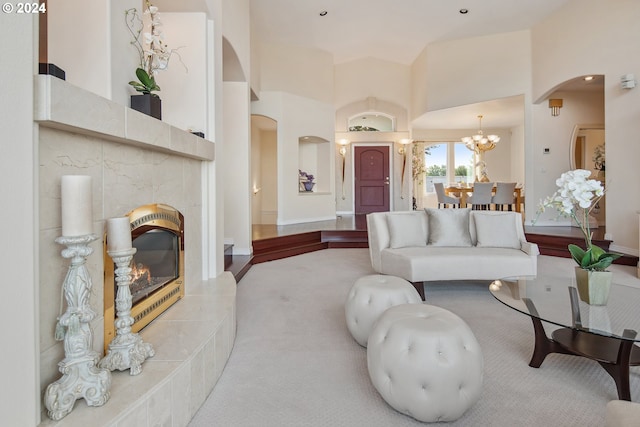 living room with a fireplace, a chandelier, and carpet