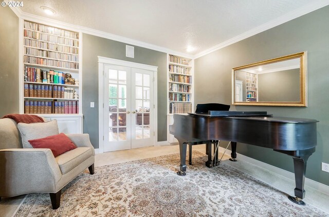 sitting room featuring built in features, crown molding, and french doors