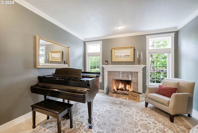 sitting room featuring a tile fireplace, a textured ceiling, and ornamental molding