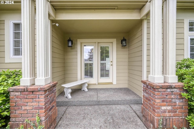 view of exterior entry with a porch