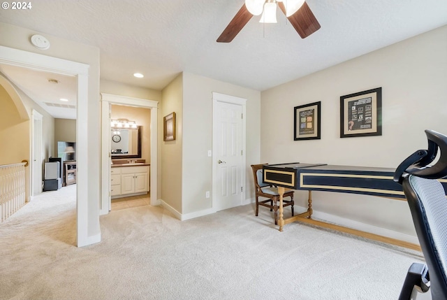 interior space with light carpet, a textured ceiling, and ceiling fan