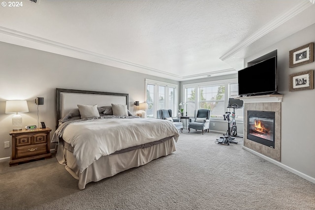 bedroom with crown molding, carpet, a textured ceiling, and a fireplace