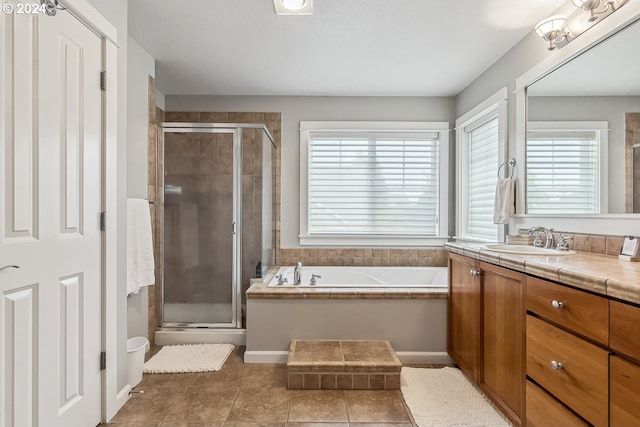 bathroom featuring vanity, independent shower and bath, and tile patterned floors