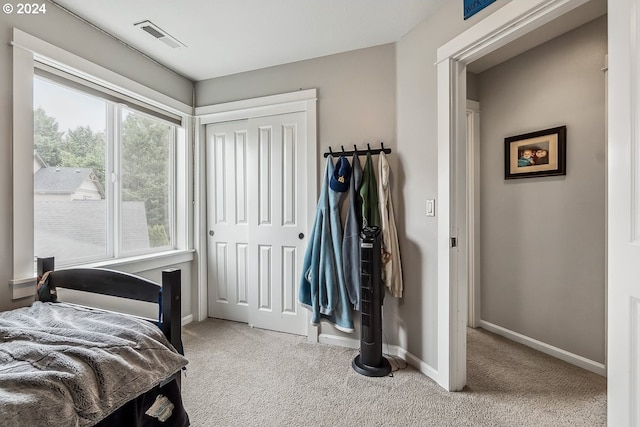 carpeted bedroom featuring a closet