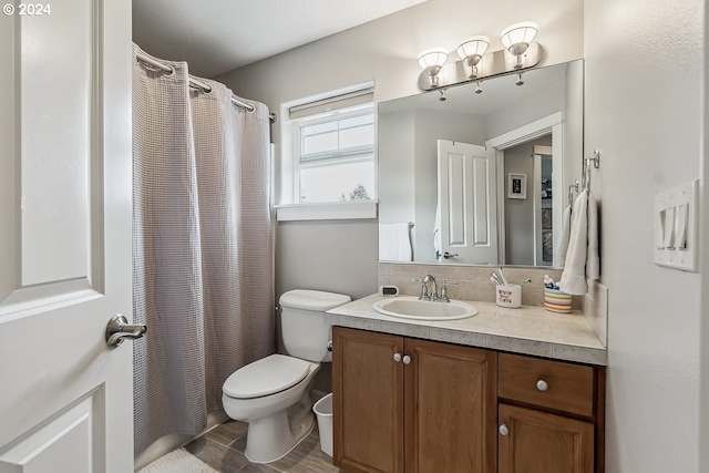 bathroom featuring vanity, toilet, and walk in shower