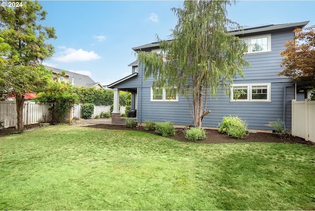 rear view of property with a yard and a patio