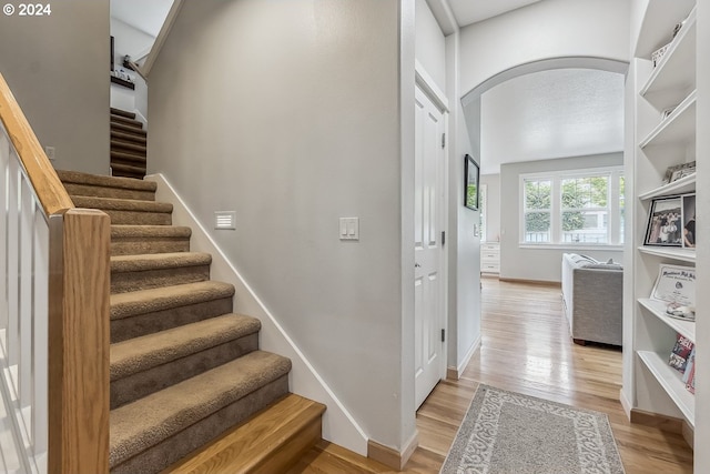 stairway with wood-type flooring