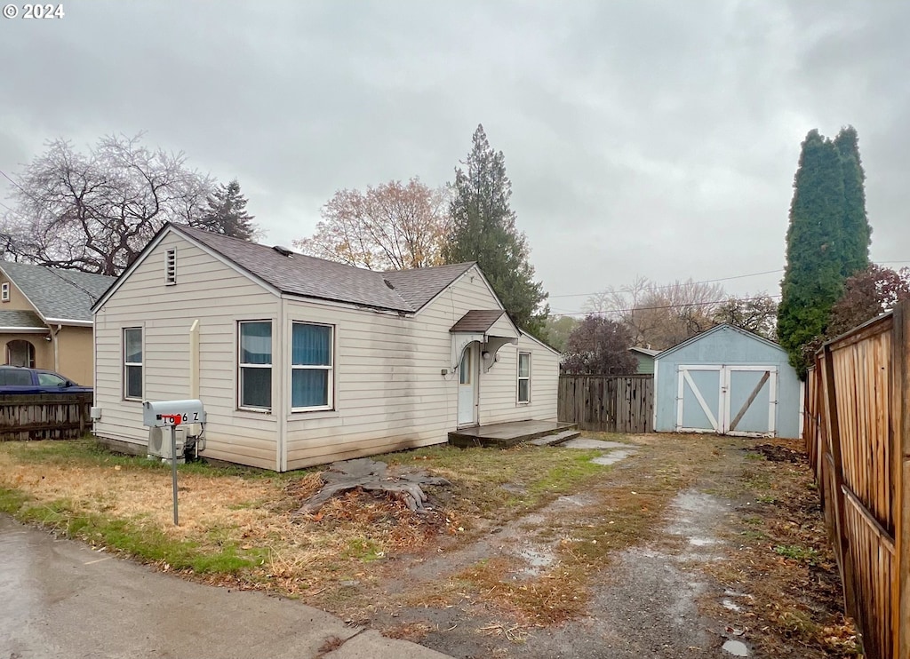 view of property exterior with a storage unit