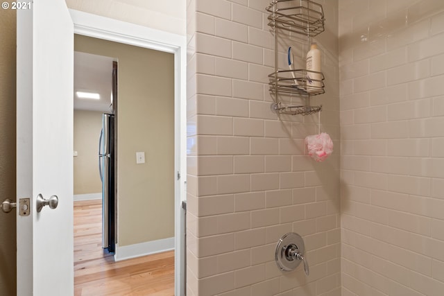 interior space featuring a tile shower and hardwood / wood-style flooring