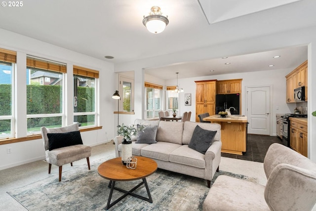 living room with recessed lighting, baseboards, and dark tile patterned floors