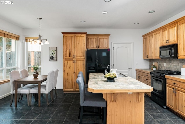 kitchen featuring black appliances, light countertops, an inviting chandelier, and a sink