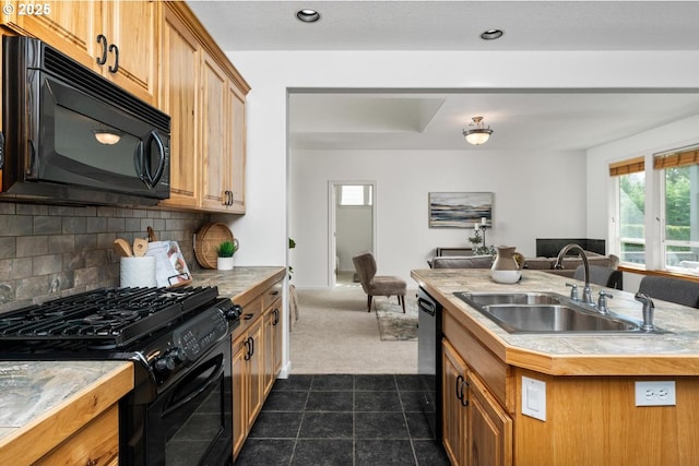 kitchen featuring backsplash, a sink, black appliances, open floor plan, and dark carpet