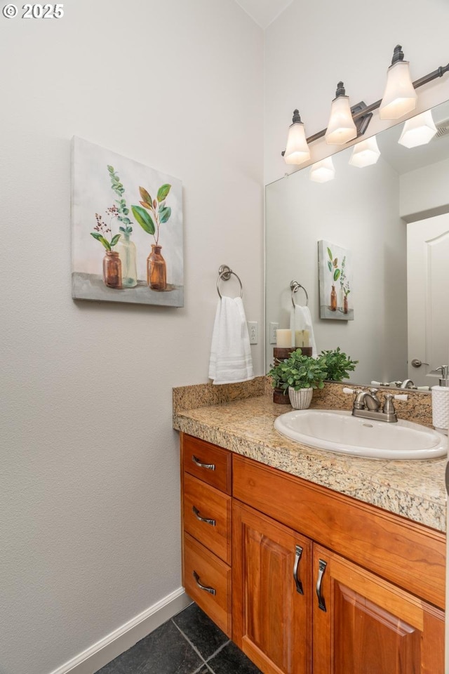 bathroom featuring vanity, baseboards, and tile patterned flooring