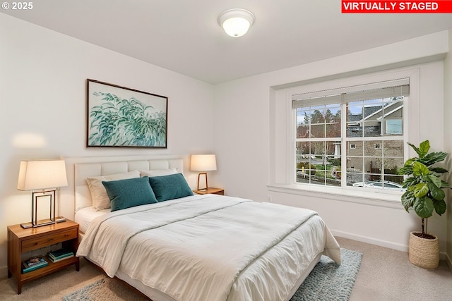 bedroom with baseboards and carpet