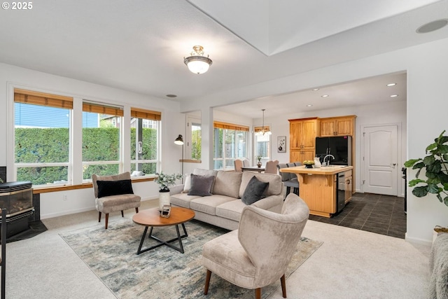 living area with a wood stove, recessed lighting, baseboards, and dark carpet