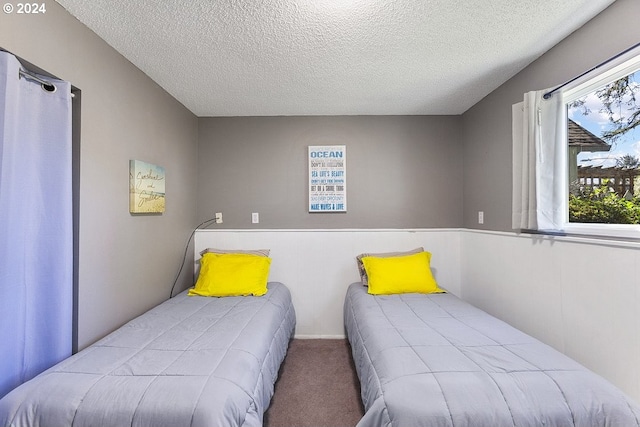 carpeted bedroom featuring a textured ceiling