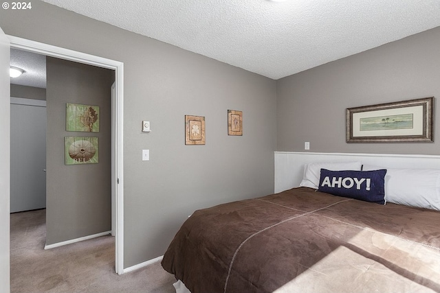 carpeted bedroom with a textured ceiling