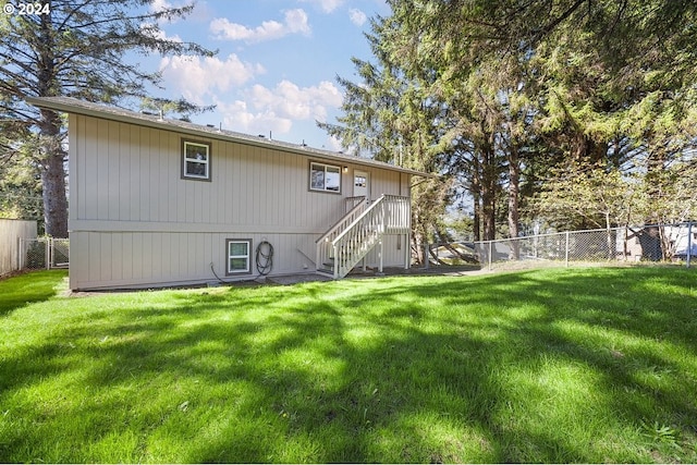 rear view of house with a lawn