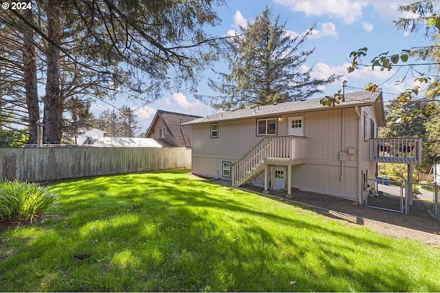 rear view of property with a lawn