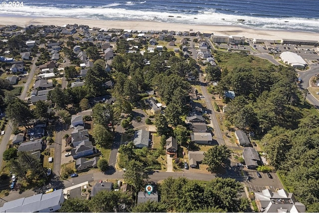 drone / aerial view with a water view and a view of the beach