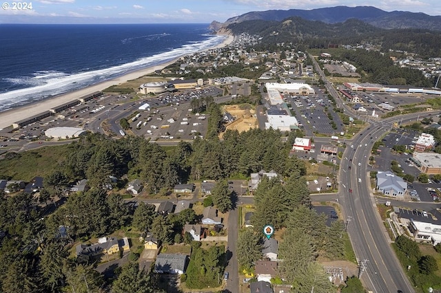 drone / aerial view with a beach view and a water and mountain view