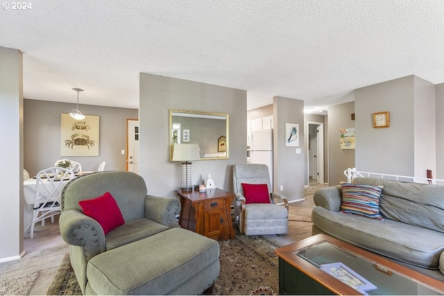 living room featuring a textured ceiling and carpet