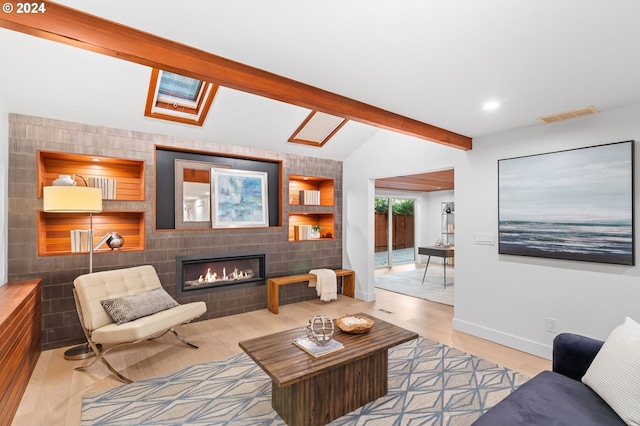 living room with light hardwood / wood-style floors, lofted ceiling with skylight, and tile walls