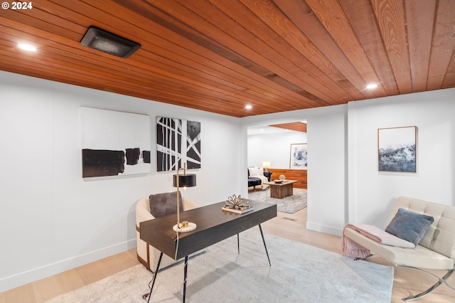 office space with light hardwood / wood-style floors and wooden ceiling