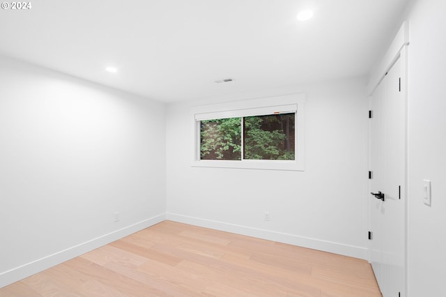 empty room with light hardwood / wood-style flooring