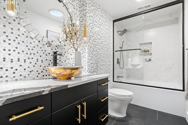 full bathroom featuring vanity, toilet, enclosed tub / shower combo, and tile patterned flooring