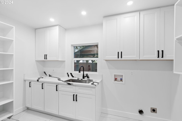 laundry area featuring cabinets, hookup for an electric dryer, sink, and hookup for a washing machine