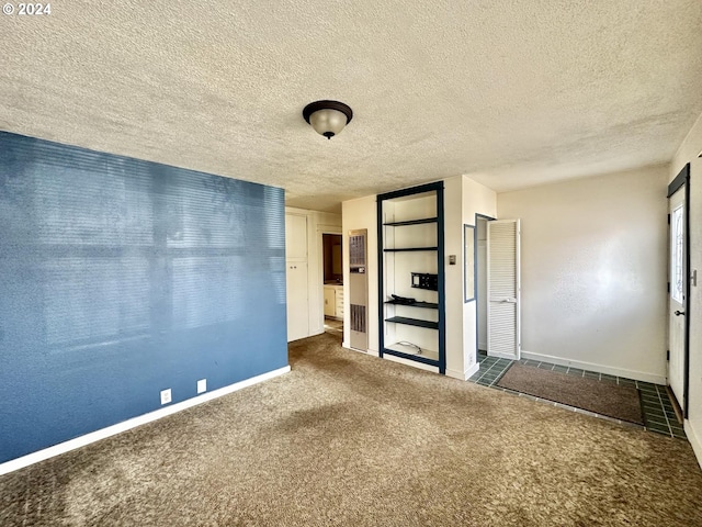 unfurnished bedroom featuring carpet flooring and a textured ceiling