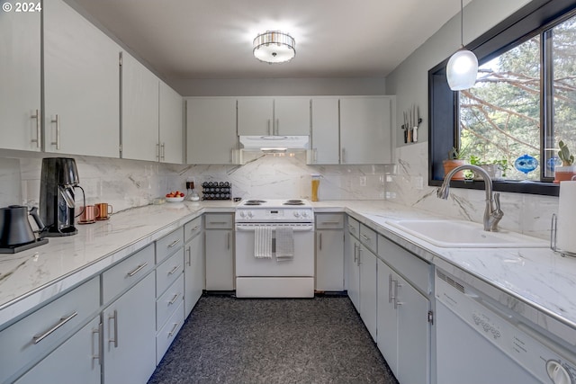 kitchen with sink, white appliances, backsplash, white cabinetry, and decorative light fixtures