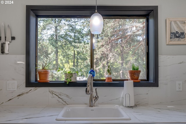 interior space with pendant lighting and sink