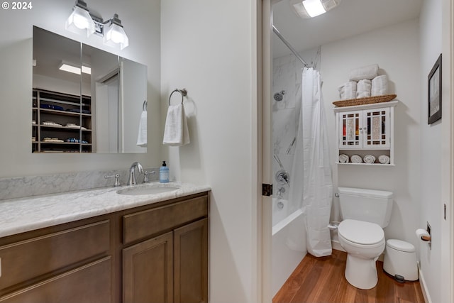 full bathroom with shower / tub combo, wood-type flooring, toilet, and vanity