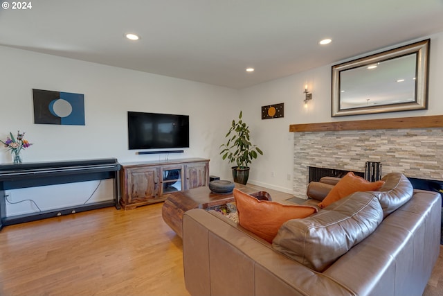 living room with wood-type flooring and a fireplace