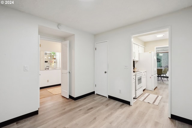 corridor featuring plenty of natural light and light hardwood / wood-style floors